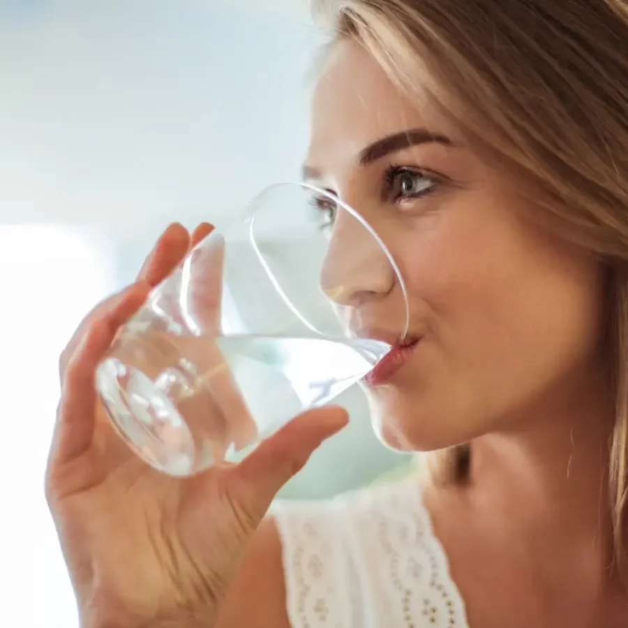 Cumberland Plateau Water Authority A woman enjoying a refreshing drink of water from a glass, emphasizing health and well-being.